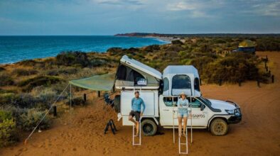 Man en vrouw leunen tegen de RedSands 4WD met de beide daktenten open