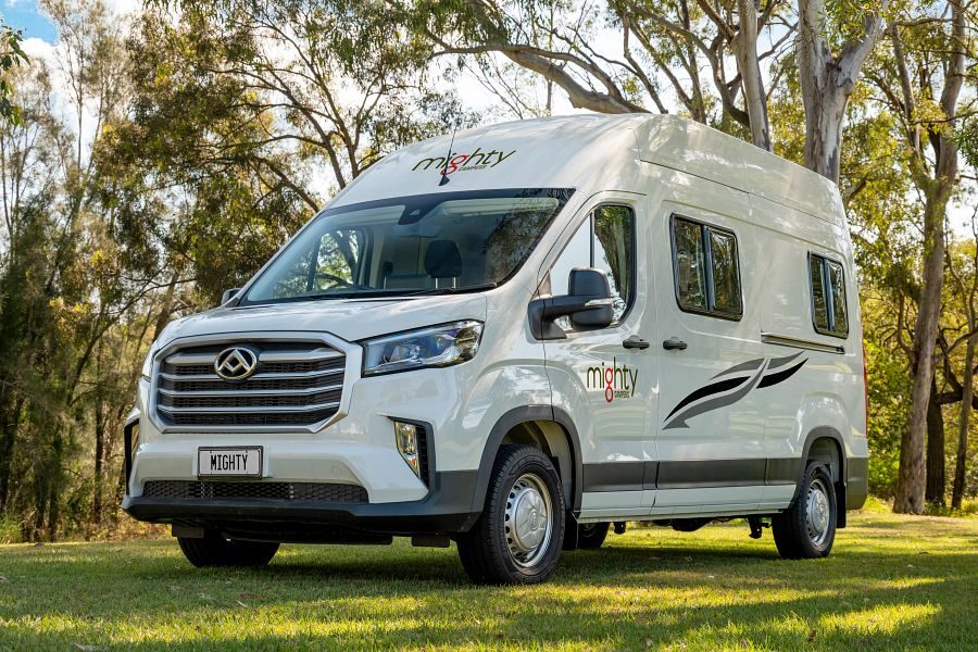 De voorkant van de in het gras geparkeerde Mighty Highball camper