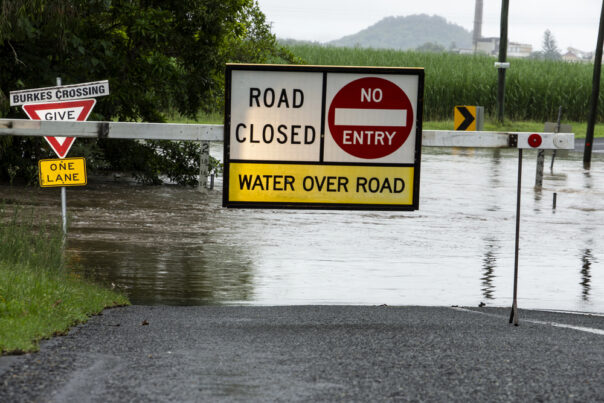 Bord dat aangeeft dat de weg is afgesloten doordat deze overstroomd is door regen